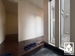 物干しスペースへと続く大きな窓から光が差し込み、外出時にも帰宅時にも、明るい気持ちになれる玄関です。