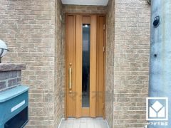 北側の玄関です。ボリューム感のあるナチュラルな木目調のドアが落ち着いた雰囲気を演出し、訪れる人々を温かく迎えます。（リフォーム前の写真です）