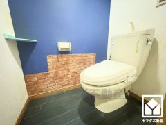 上品な壁紙と遊び心のあるタイルデザインが魅力的なトイレ空間。機能性とセンスが融合した、居心地の良いプライベートスペースです。